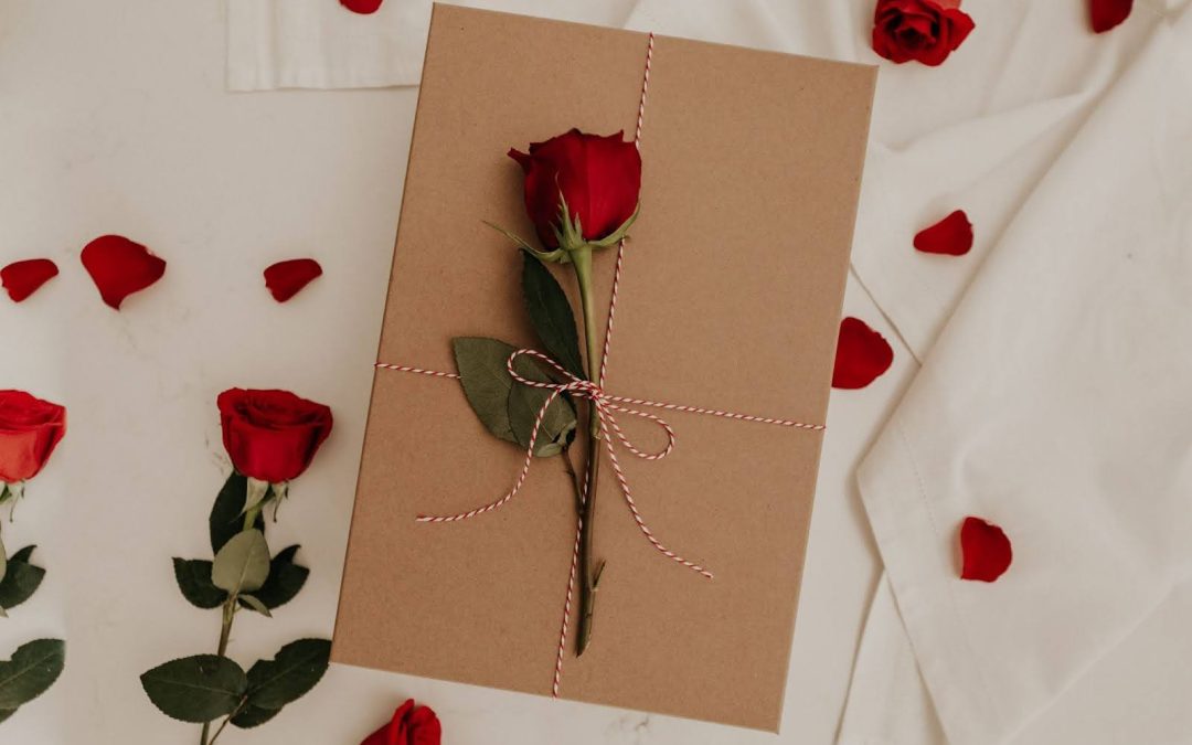 A red rose on a brown envelope decorated romantically.
