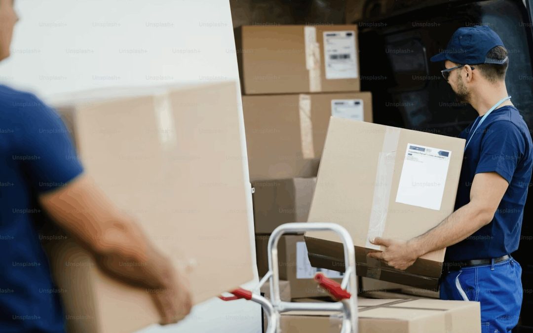 Man carrying packaging box, loading it into a truck.